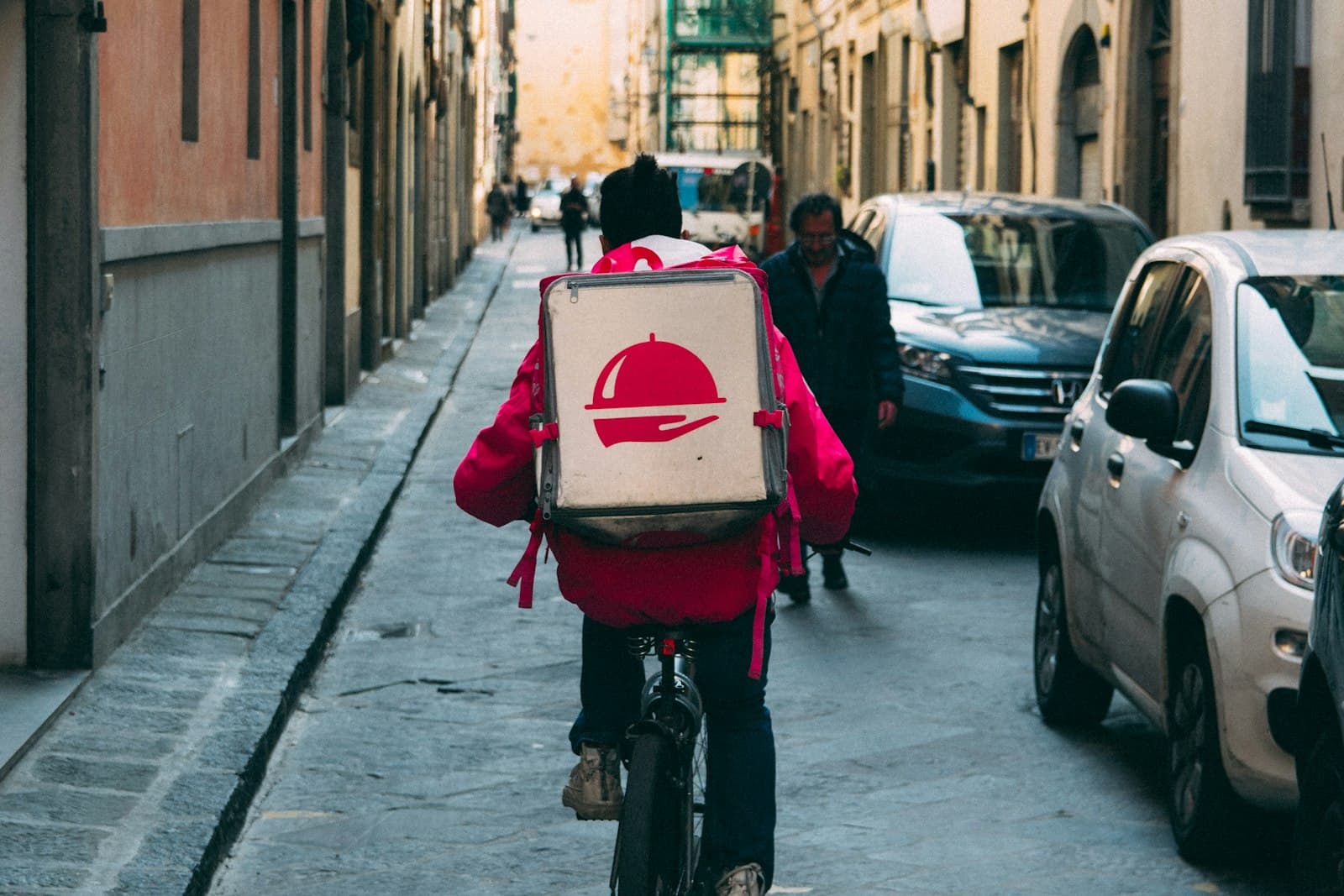 A food-delivery rider heading down a high street
